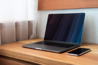 modern-laptop-on-wooden-desk-1080x720